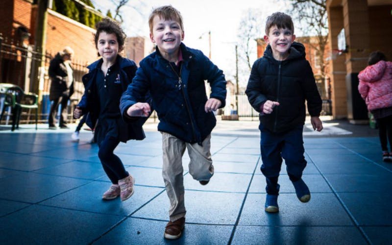 Three children running forward