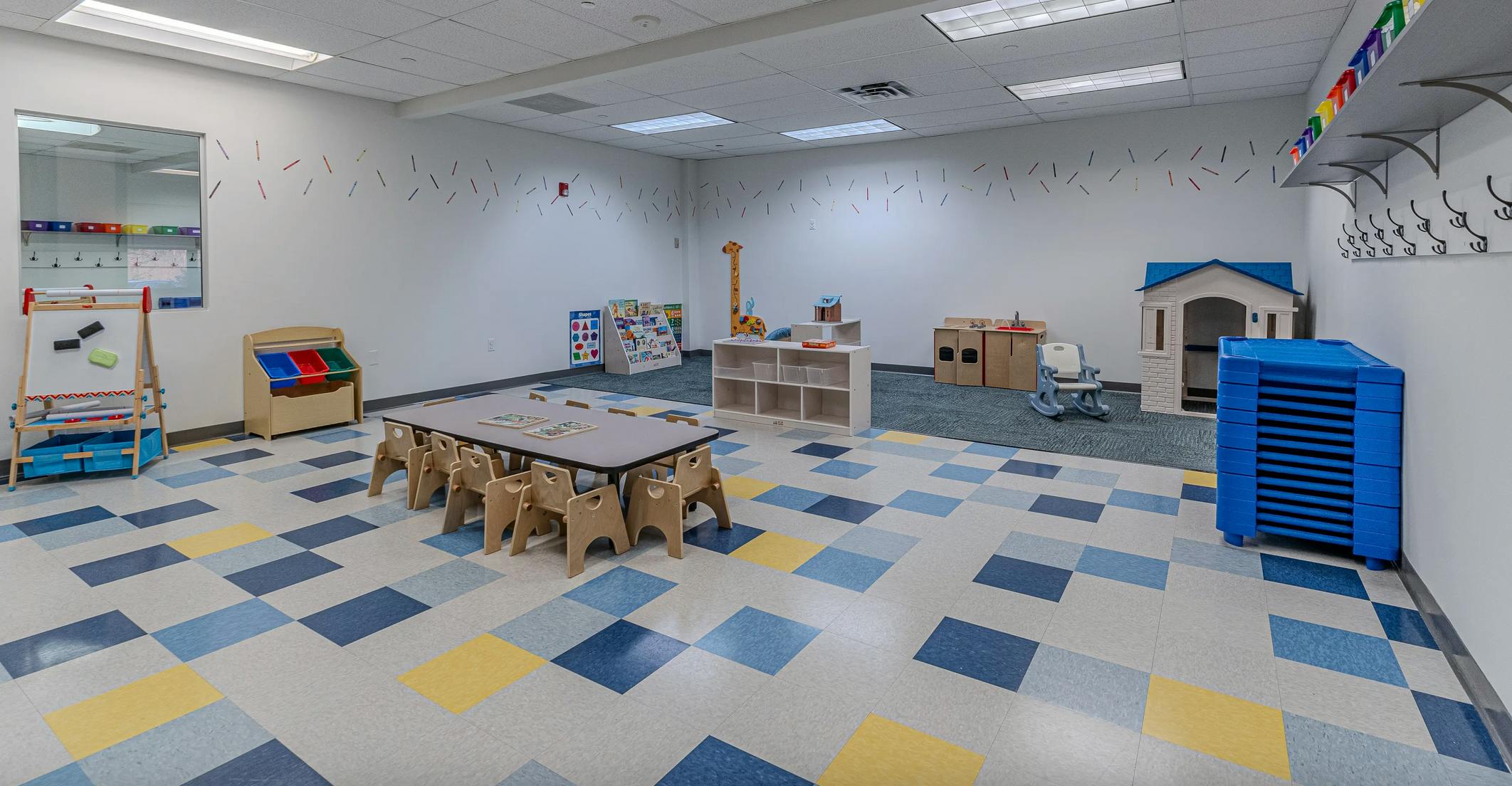 Empty classroom with small tables and chairs