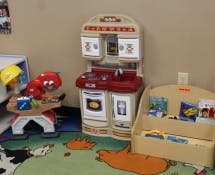 Toy kitchen and other toys in a room