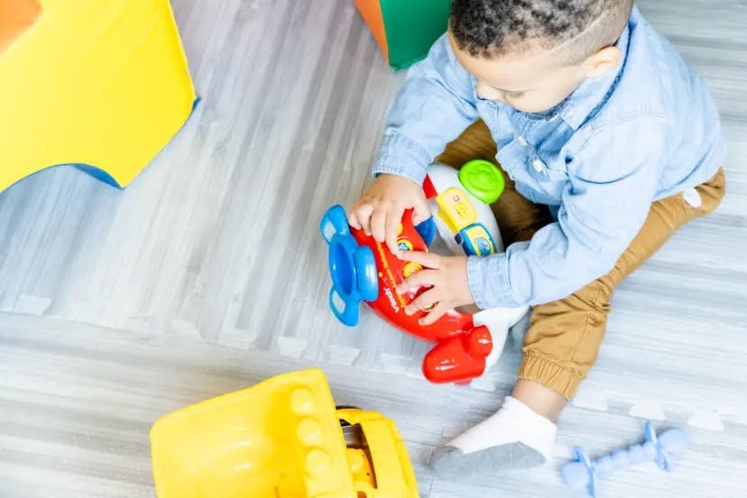 Child playing with a toy airplane