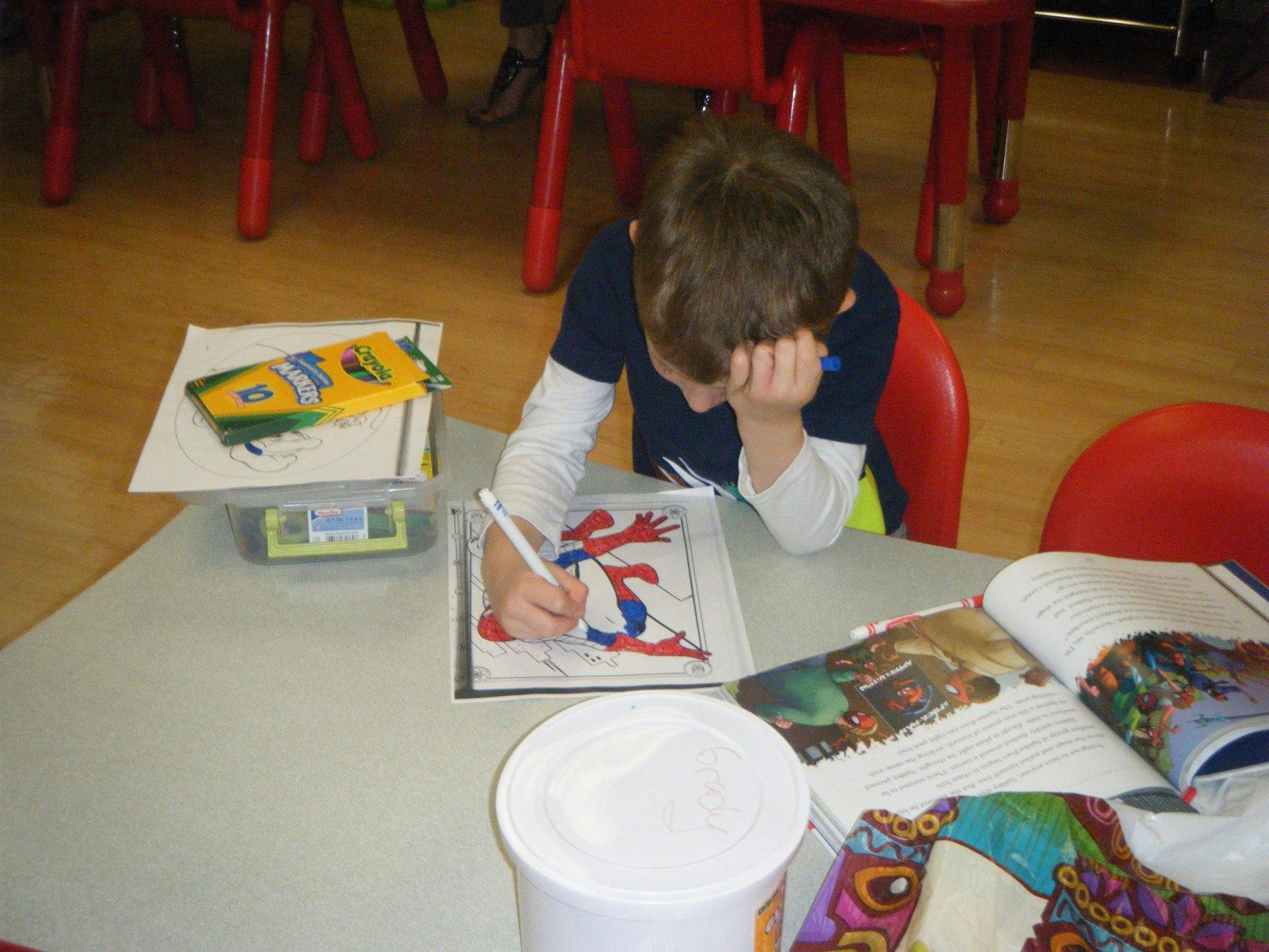 Child coloring a drawing at a table