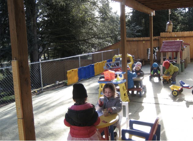 Children playing with toys in an outdoor area
