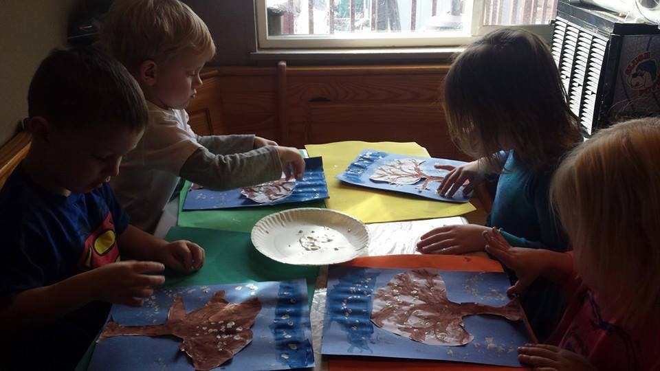 Children doing crafts at a table