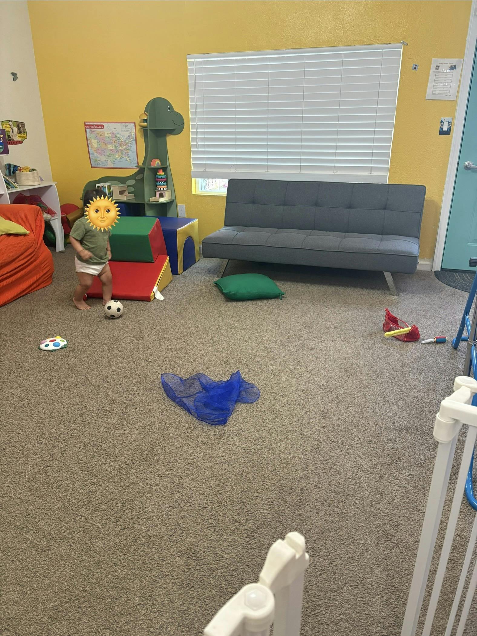 Child playing with a ball in a playroom