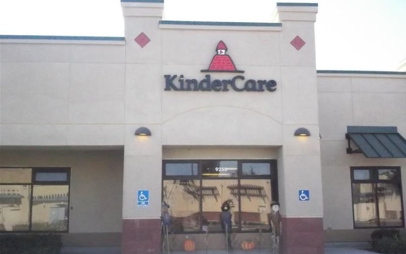 KinderCare building entrance with pumpkins and scarecrows