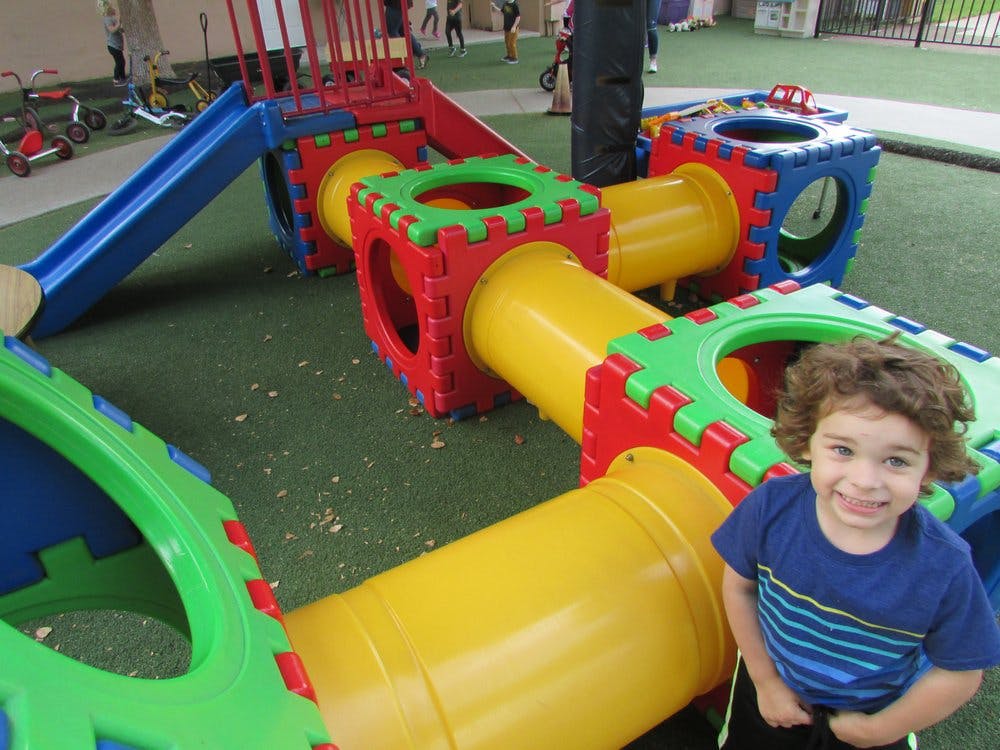 Child on a playground with colorful play equipment