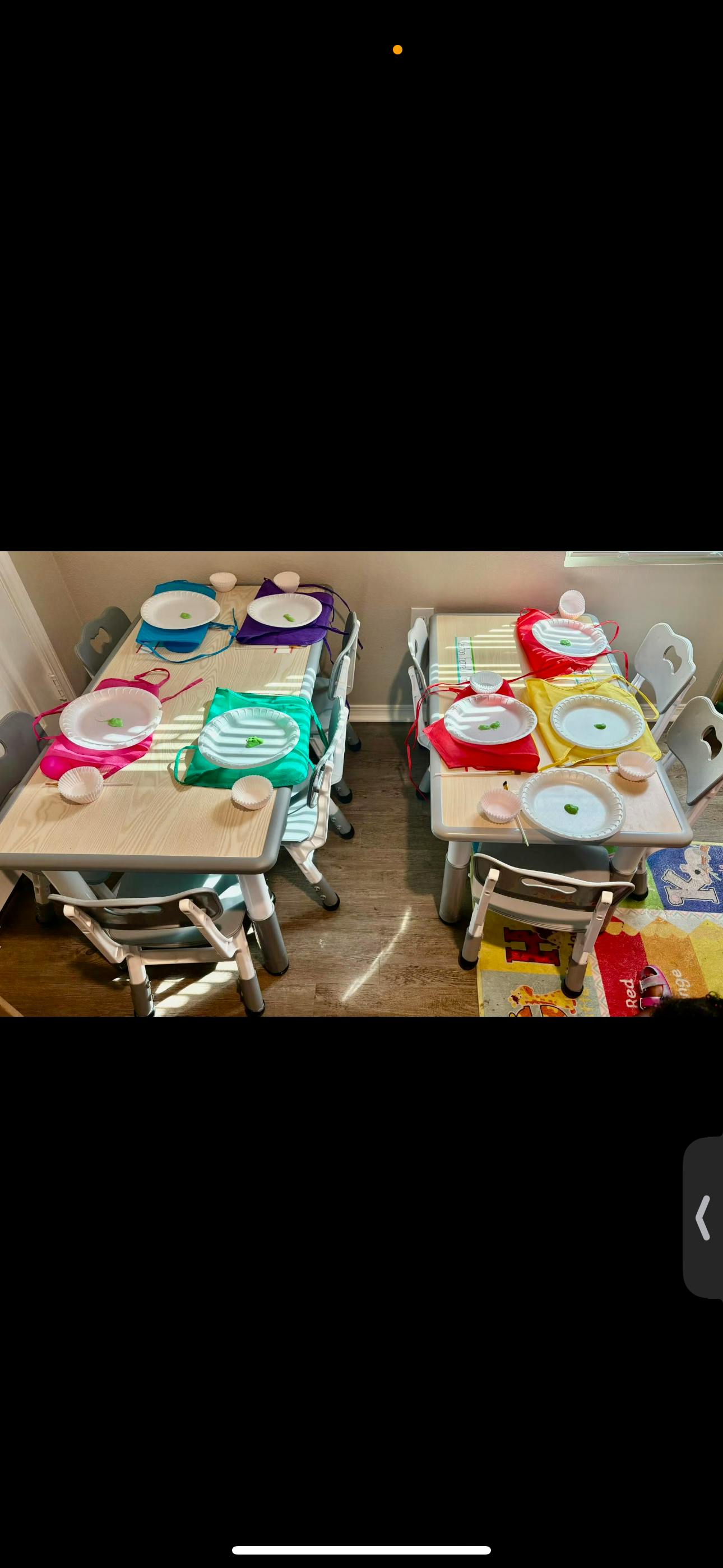 Child-sized tables set with plates, small bowls, and colorful aprons