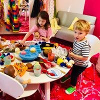 Two children playing with toys at a table
