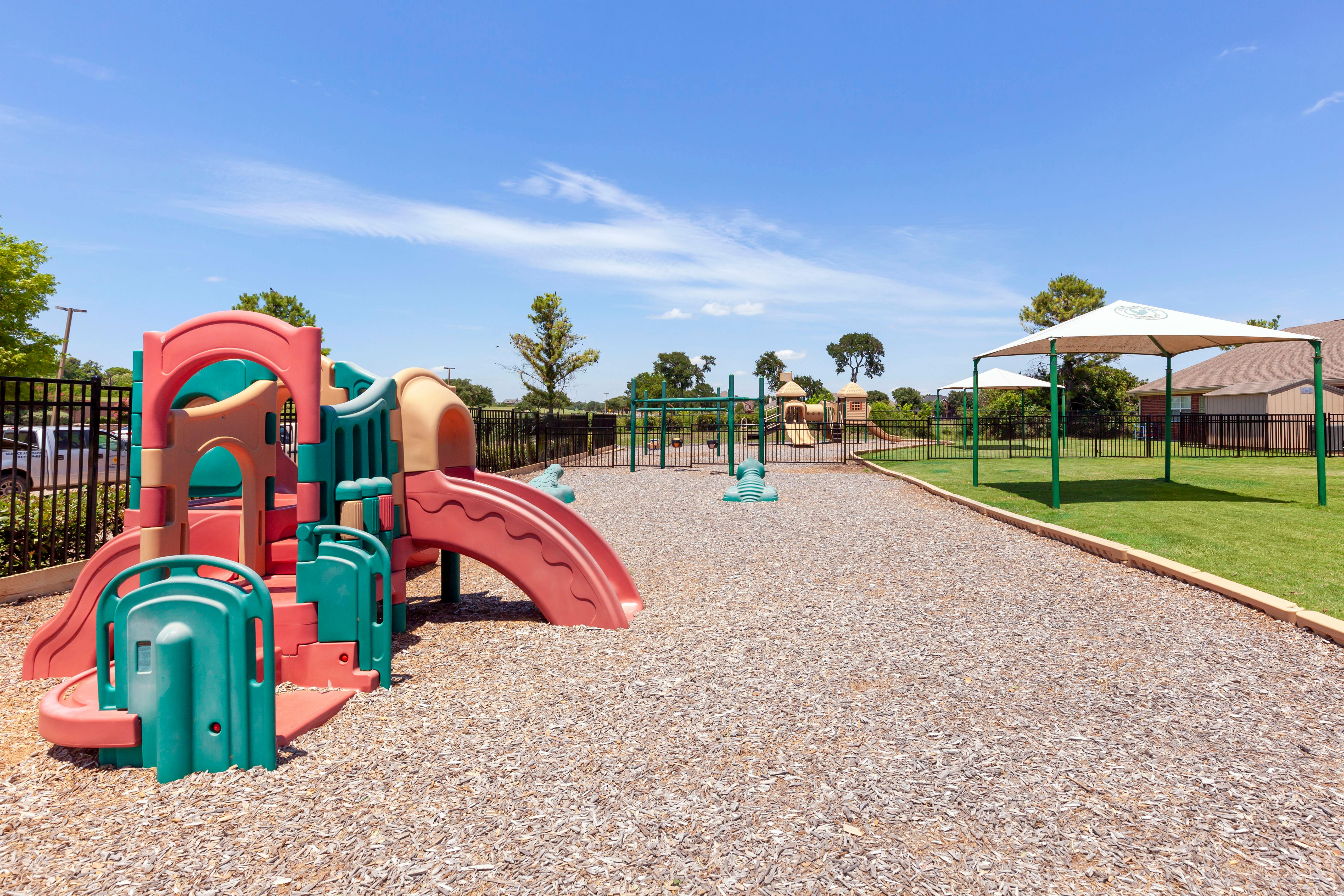 A children's playground with a large climbing structure and slide