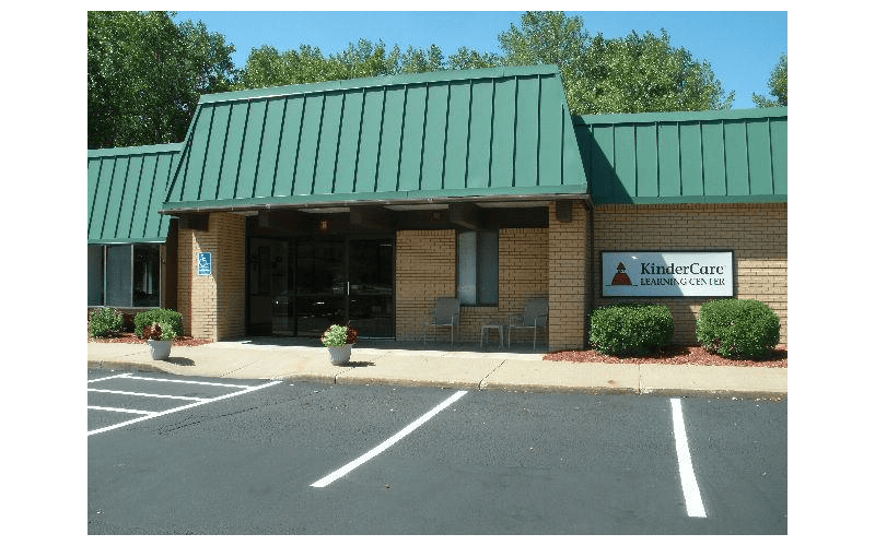 Brick building with green roof and a sign that reads KinderCare Learning Center