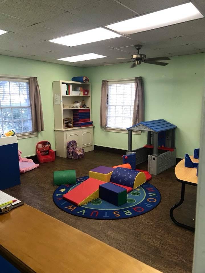 Playroom with soft play equipment on an alphabet rug