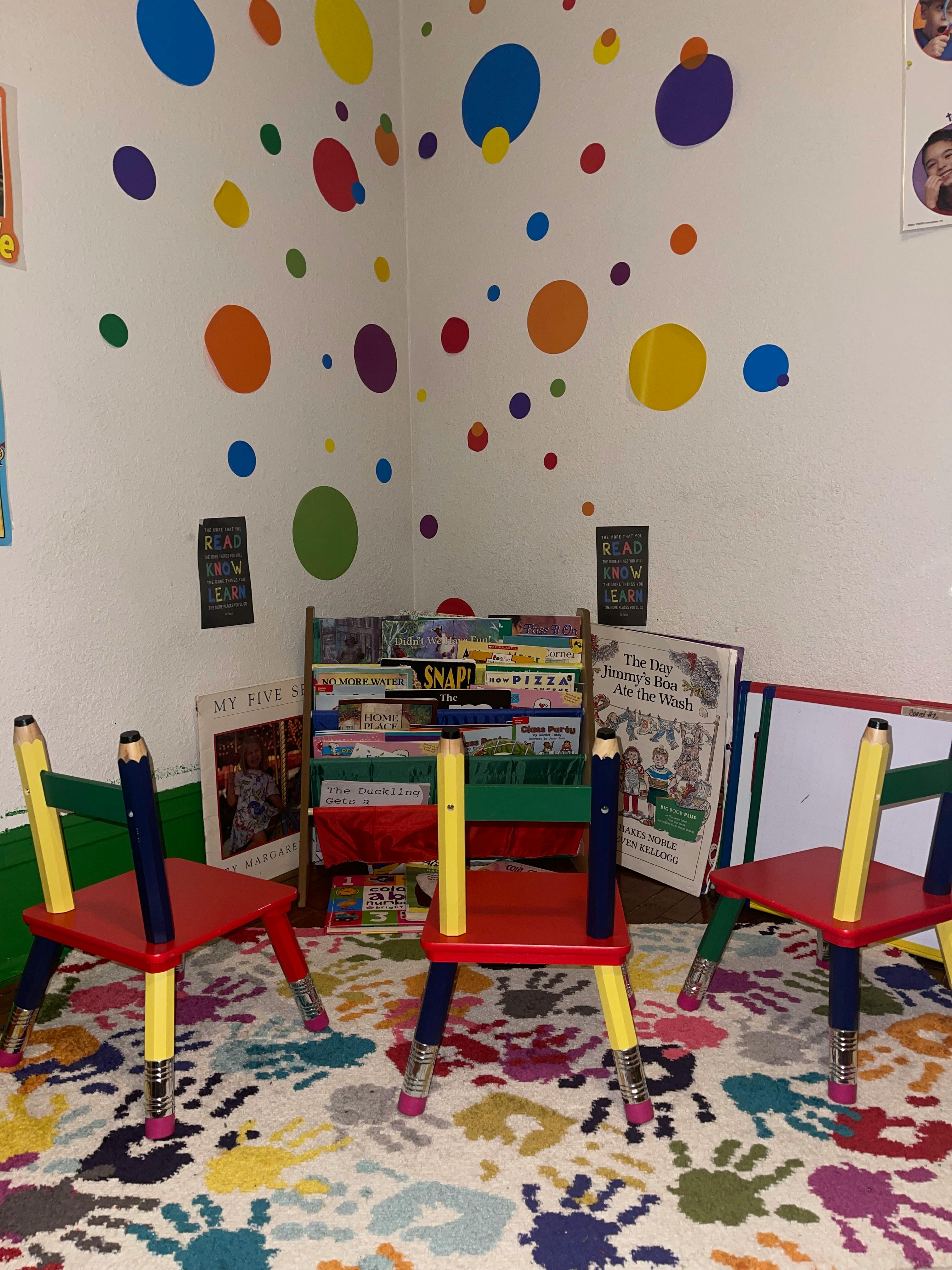 Children's chairs with pencil-shaped legs in a colorful room with a bookshelf