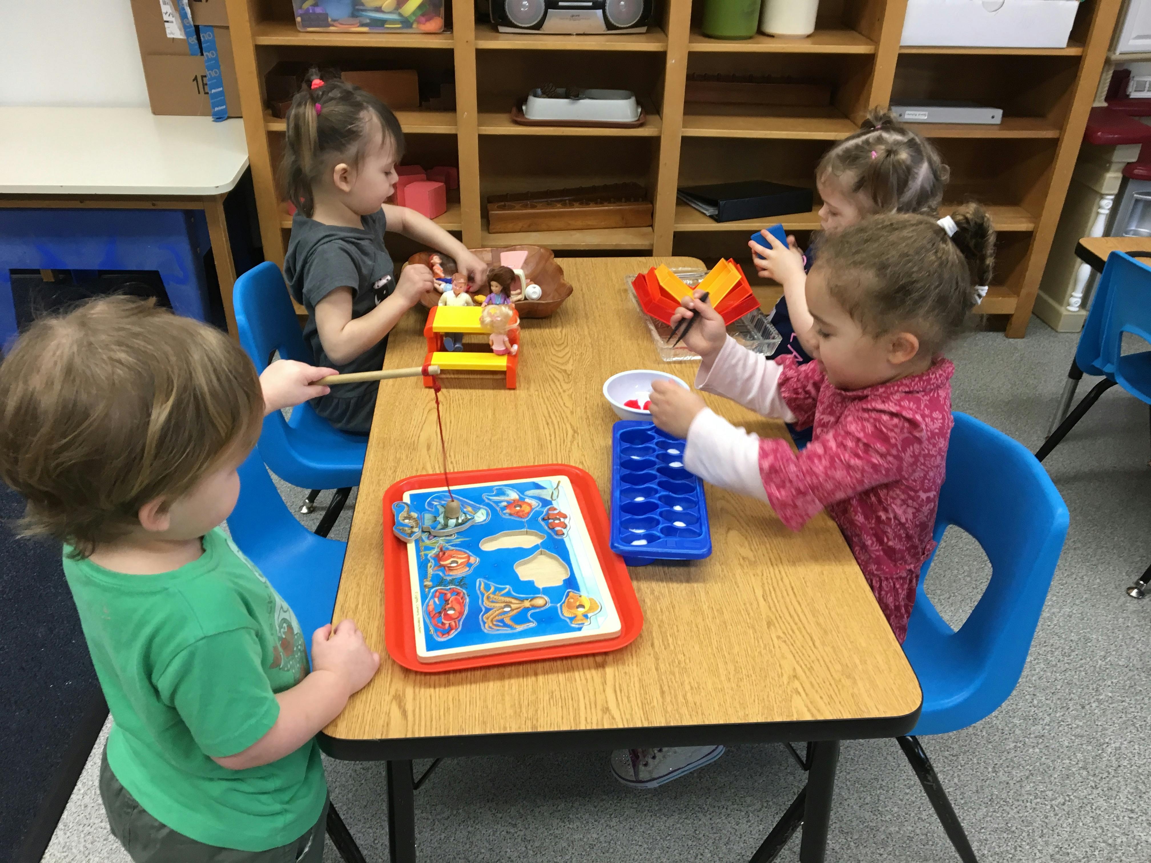Children playing with toys at a table