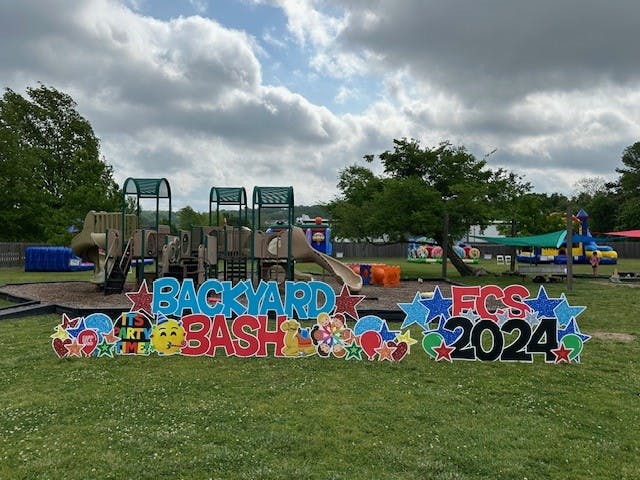 Backyard Bash FCS 2024 sign in front of a playground