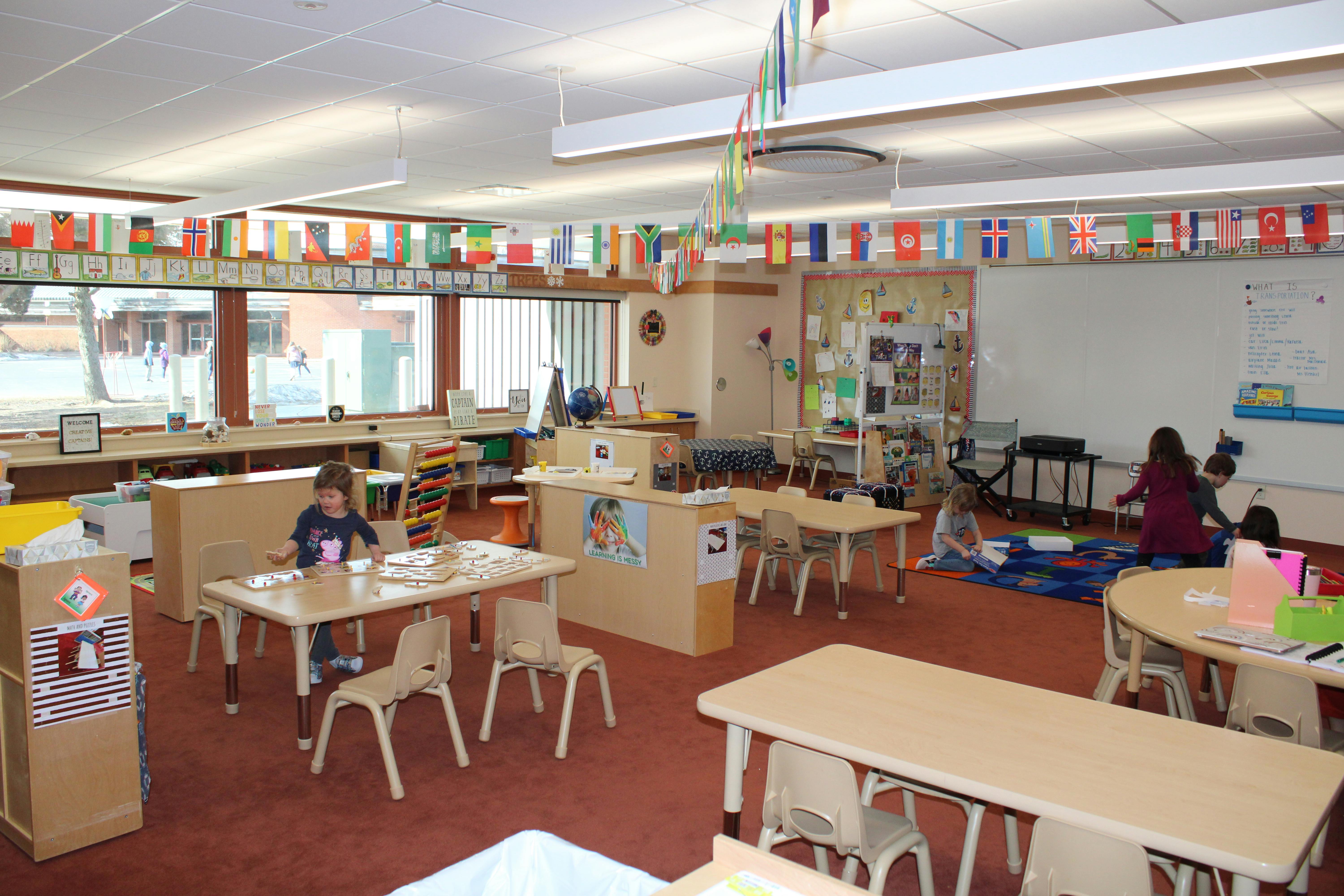 Child sitting at a table in a classroom