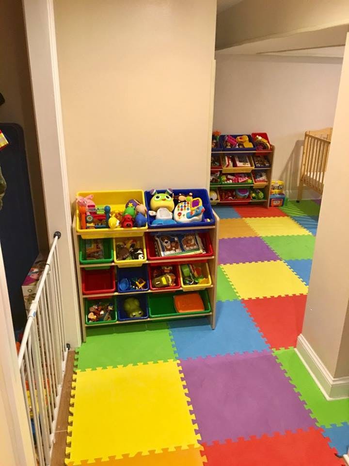 Playroom with colorful foam floor tiles and toy storage shelves