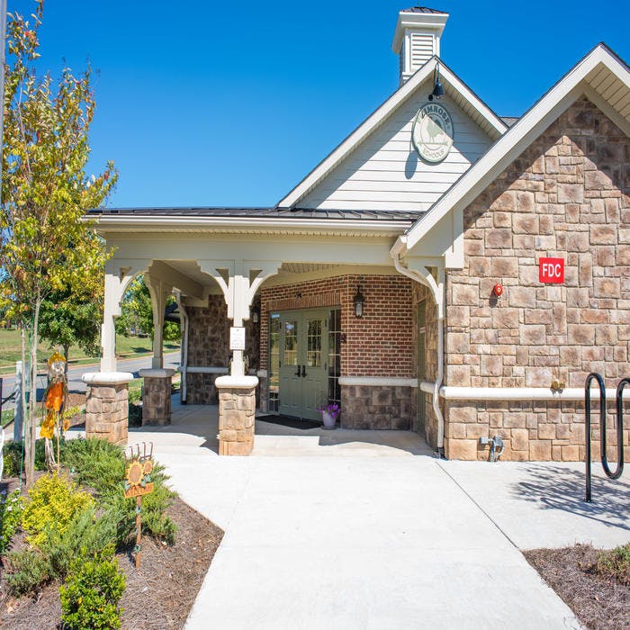 Building exterior with a covered entrance and stone facade