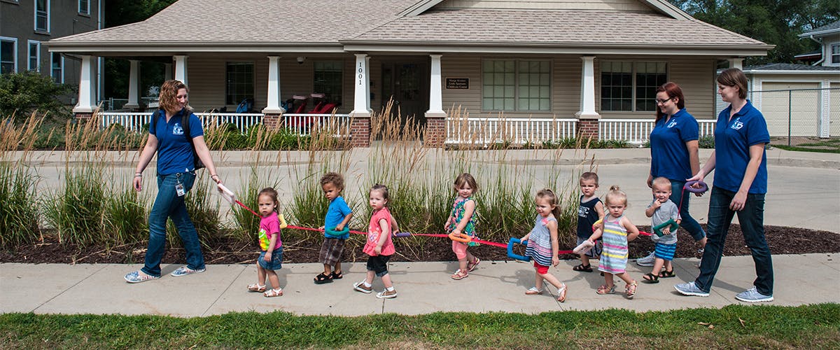 People walking with children on a sidewalk