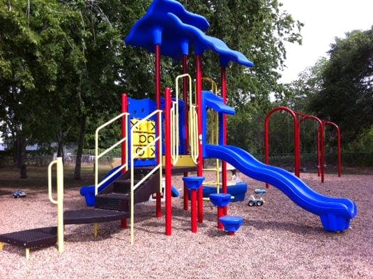Playground with blue slides and red support beams