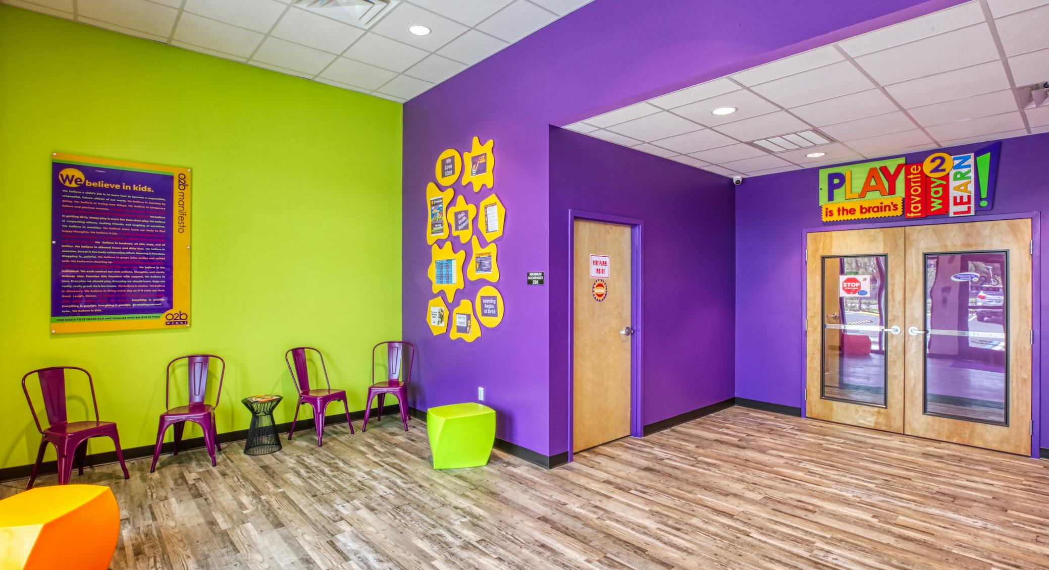 waiting area with purple chairs and brightly colored walls