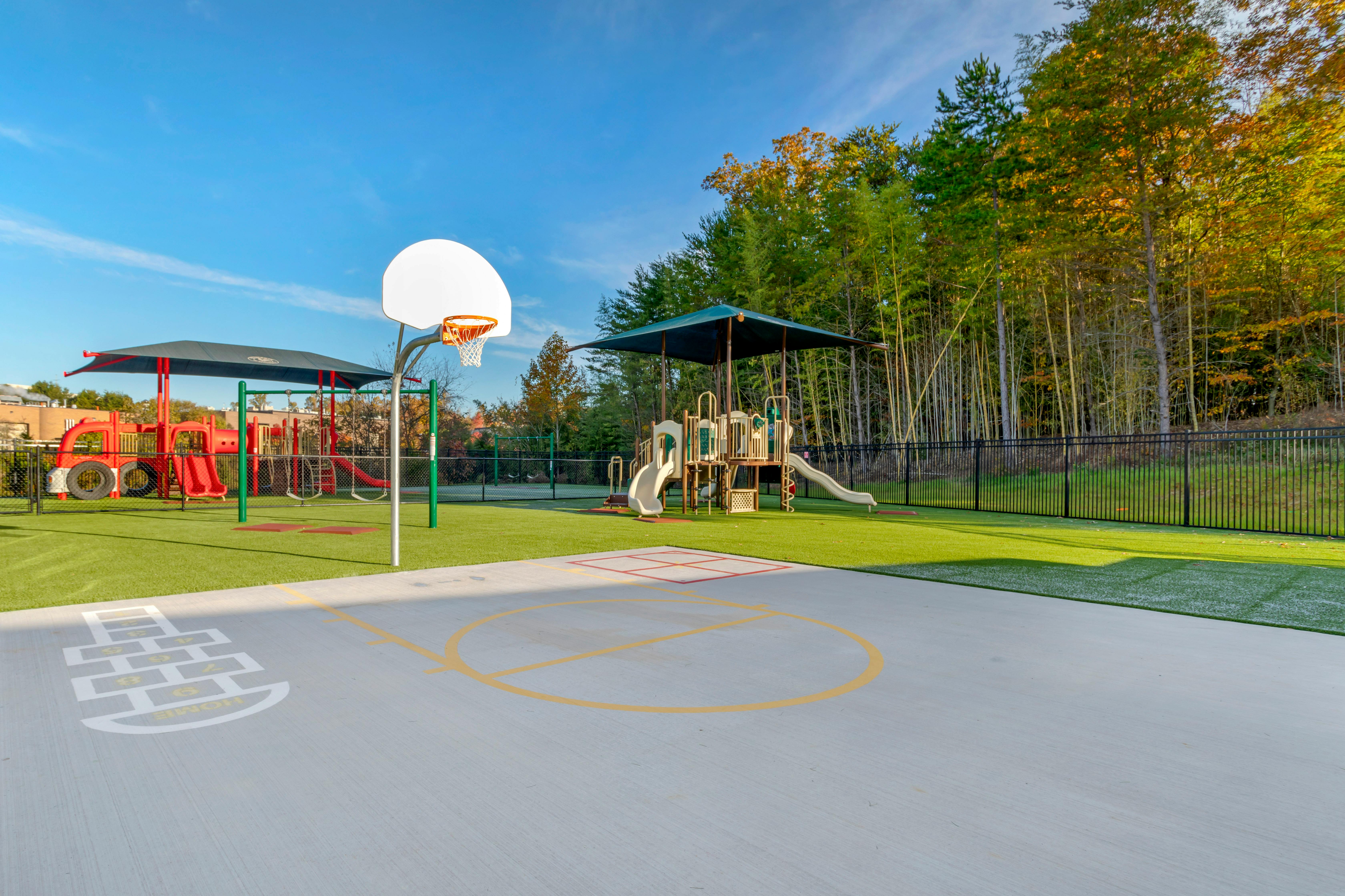 Basketball hoop with hopscotch and playground equipment