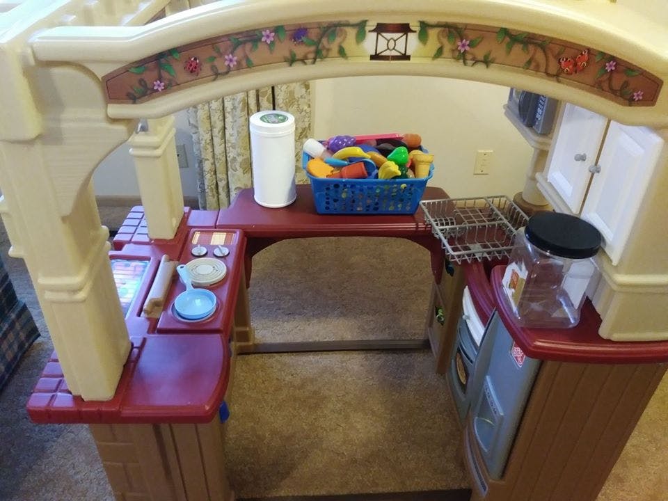 Child's play kitchen with toy food and dishes