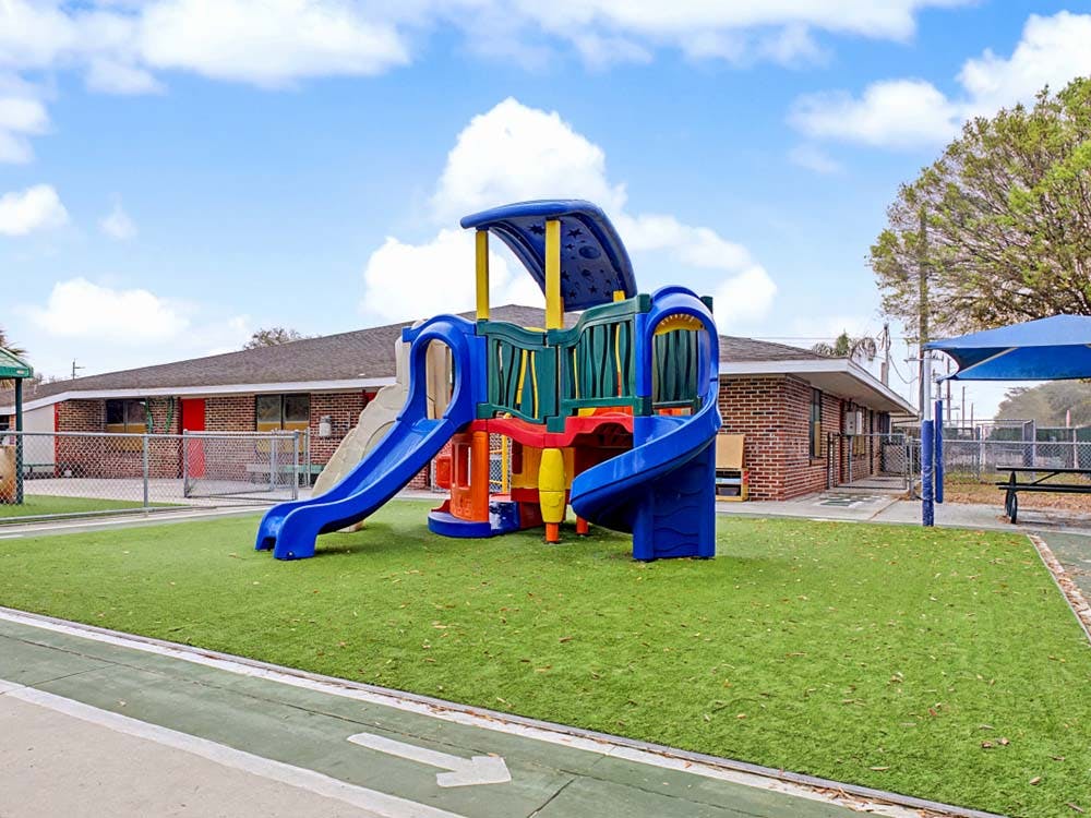Colorful playground structure with slides on artificial turf