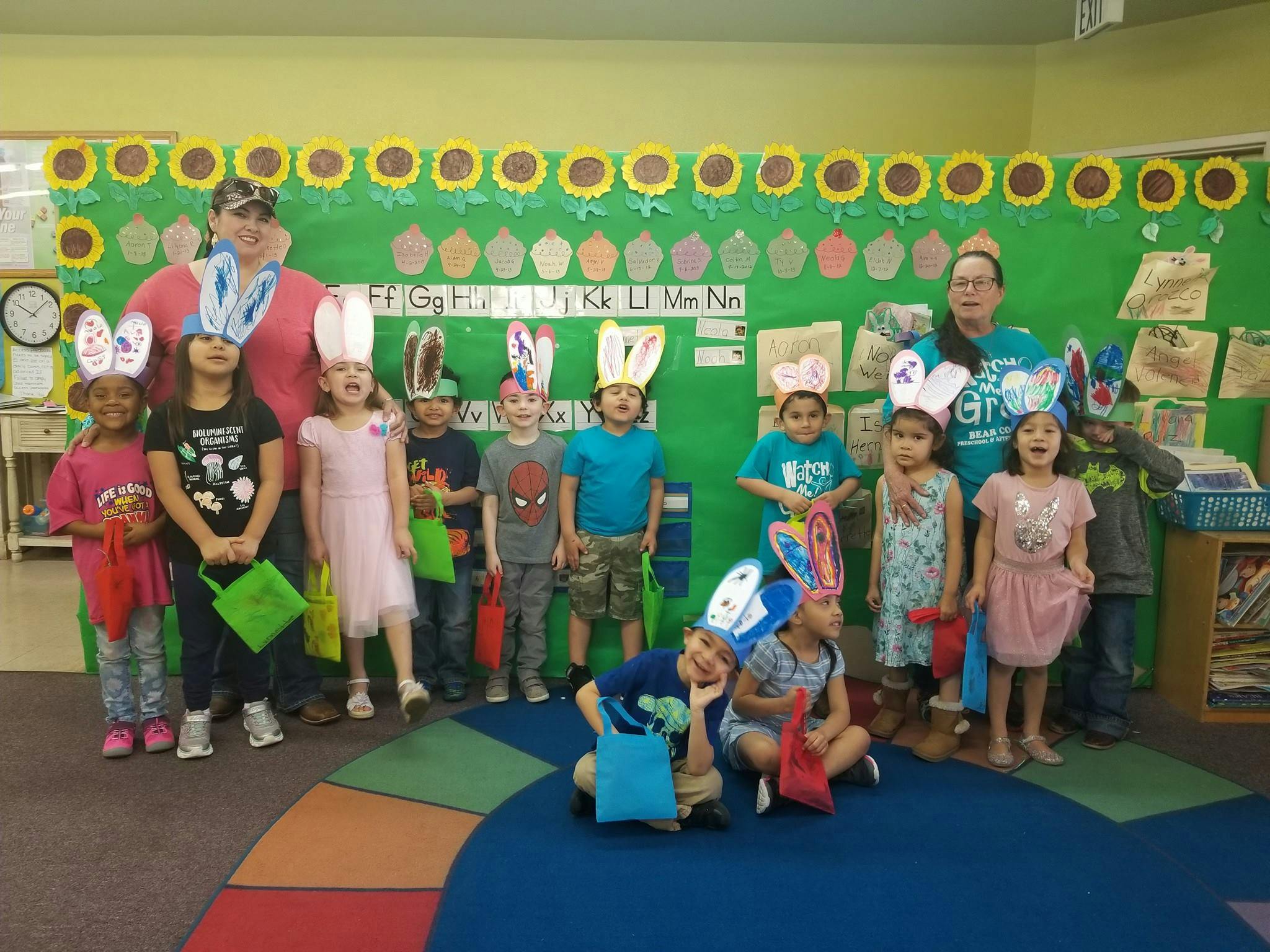 Adults and children wearing bunny ears and holding bags