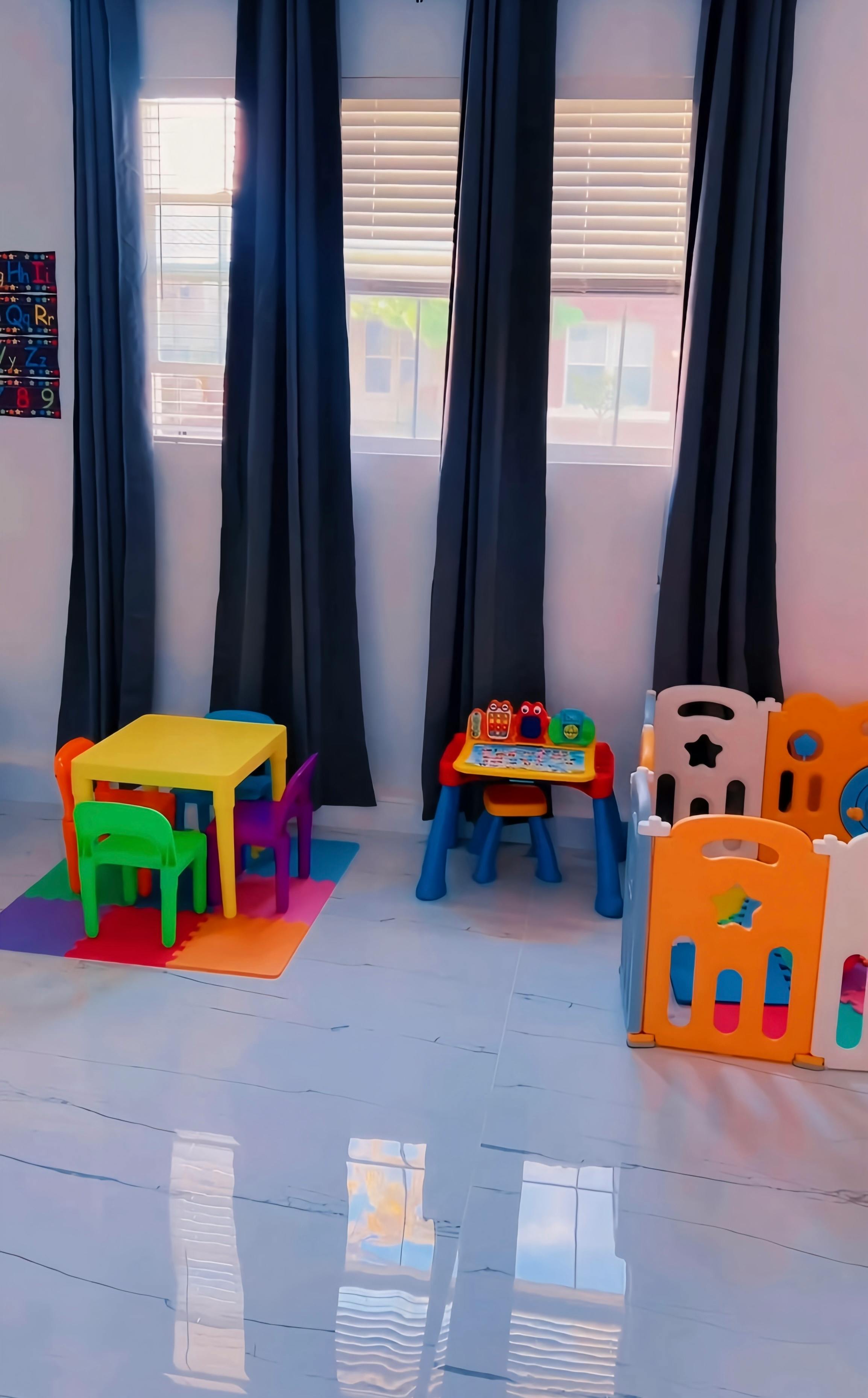Children's play area with small tables and chairs