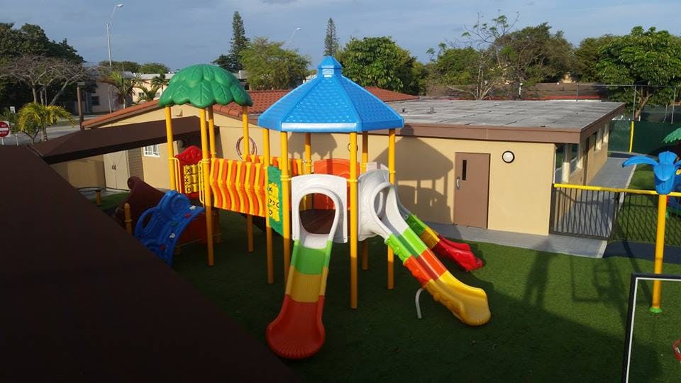 Colorful playground with slides and climbing structures on artificial turf