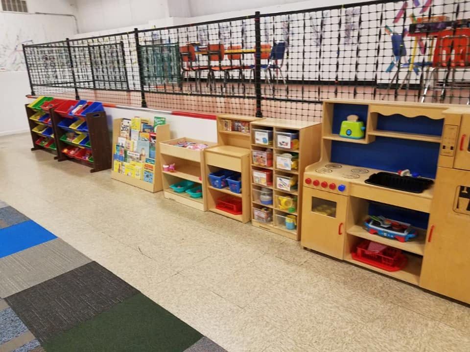 Children's play kitchen and storage shelves in a classroom