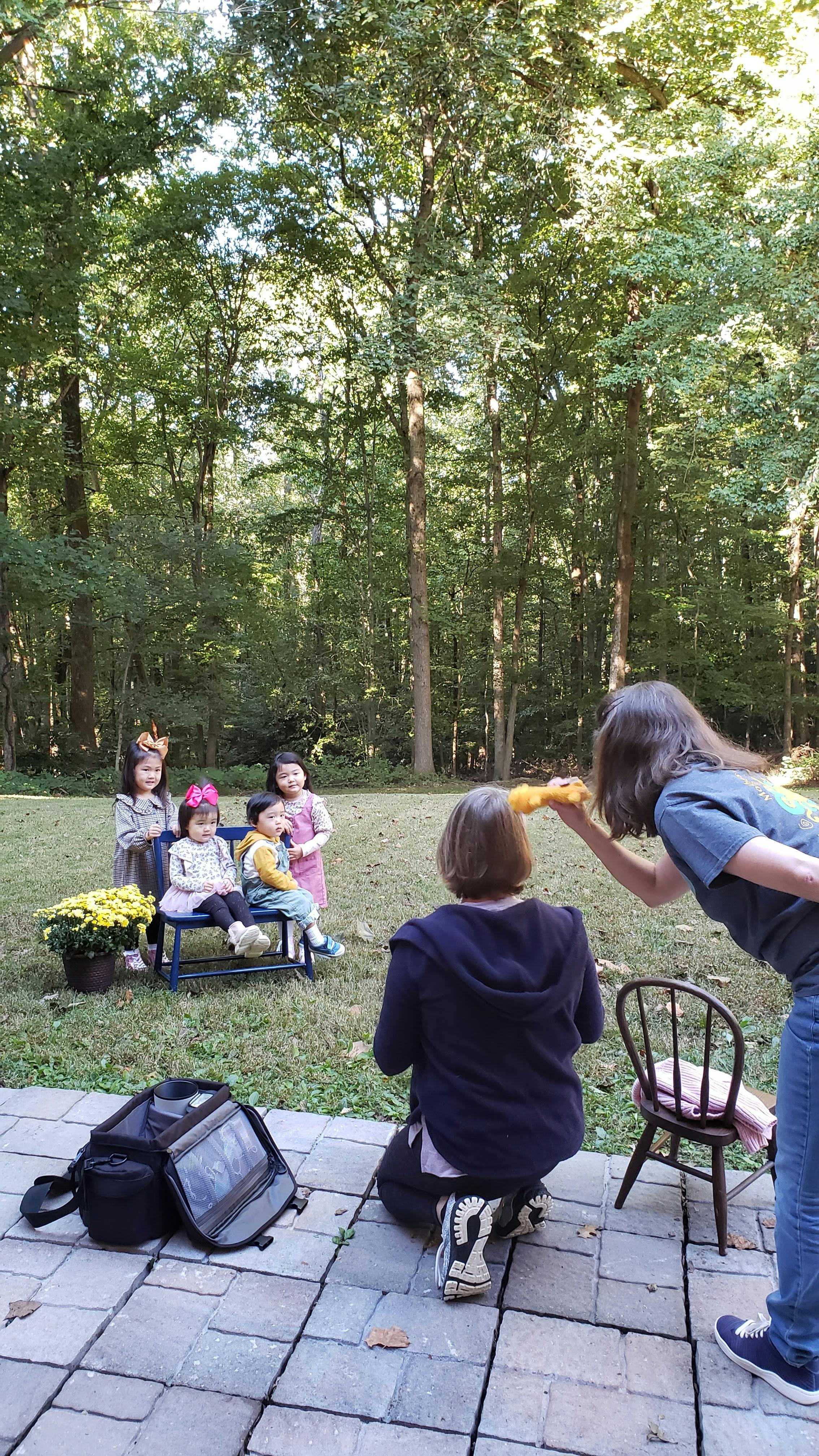 Adults interacting with children outdoors