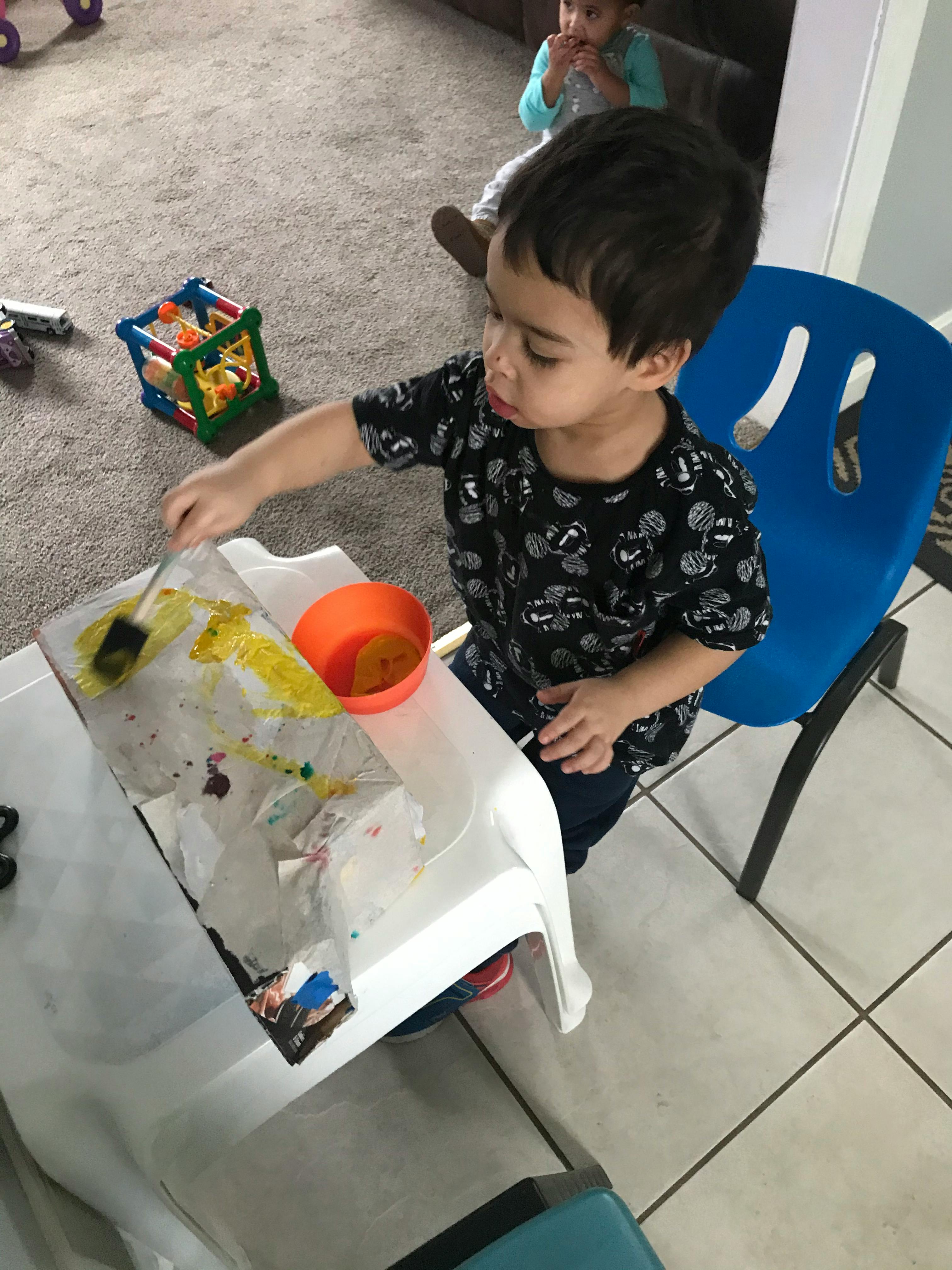 Child painting at a small table