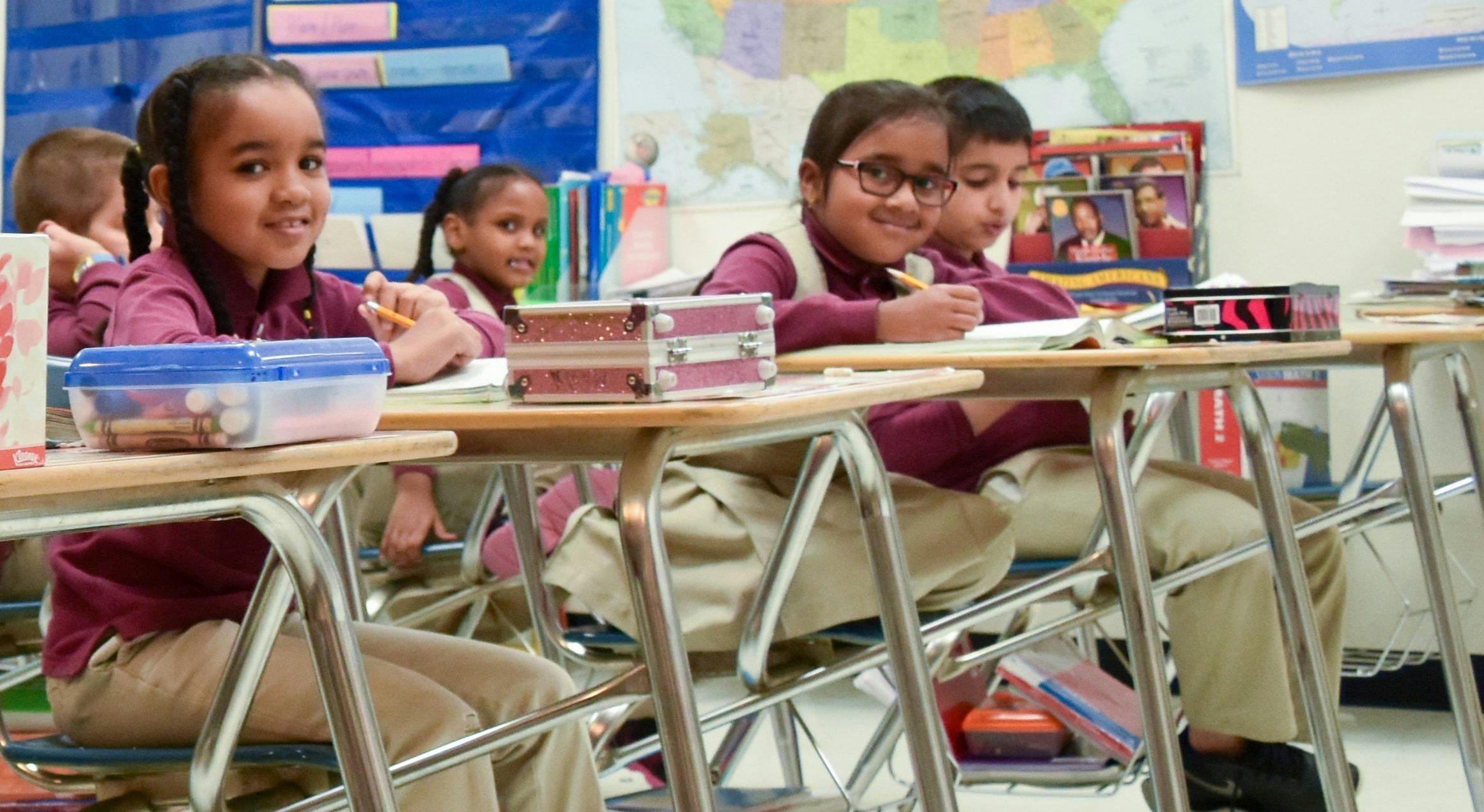 Children sitting at desks in a classroom