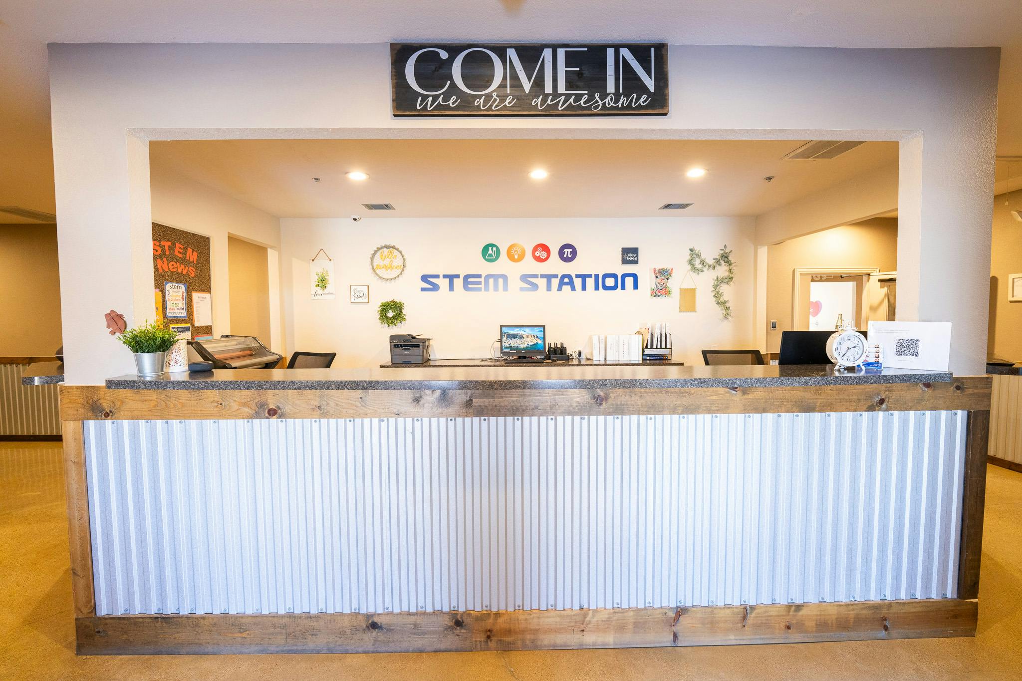 Reception desk with STEM Station sign in a modern facility