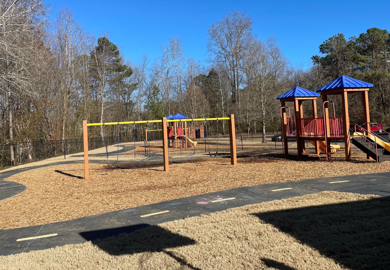 Empty playground with swings, slides, and climbing structures