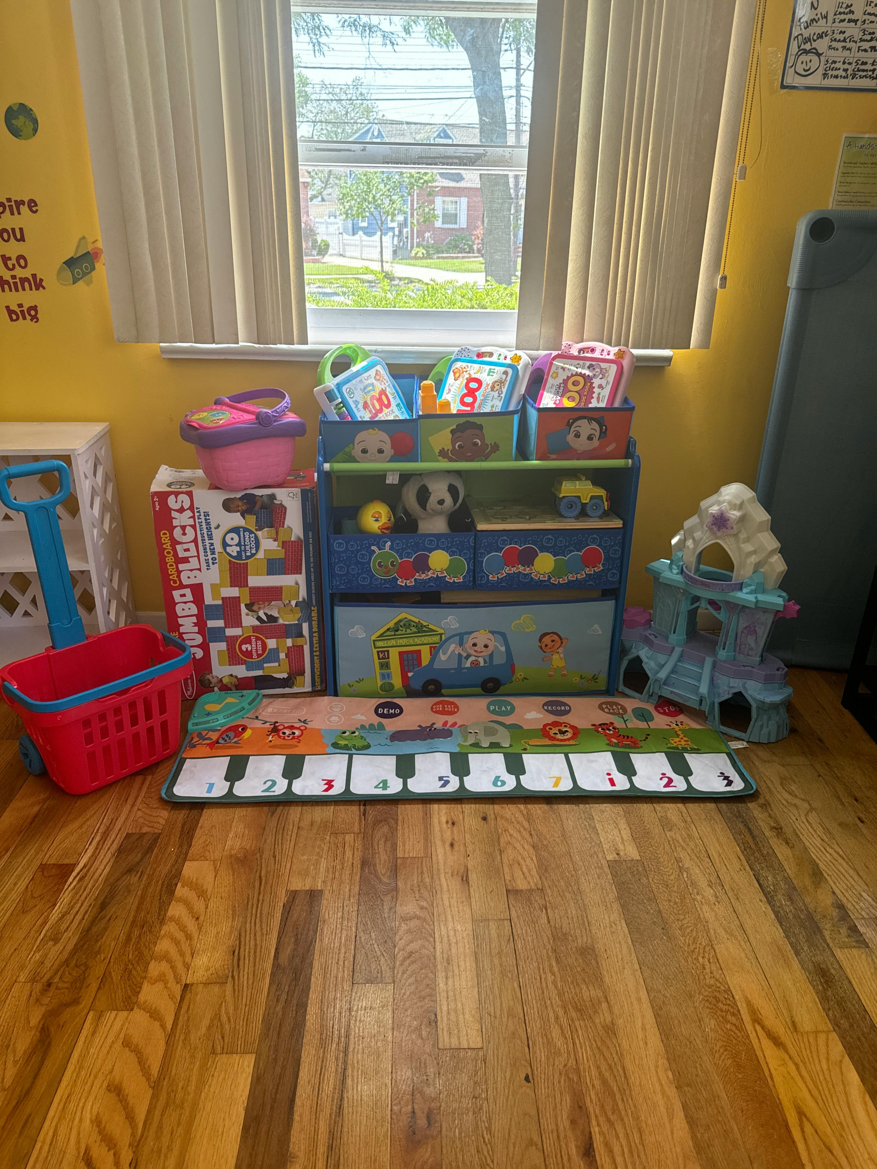 Children's toys and storage bins in a room with a window