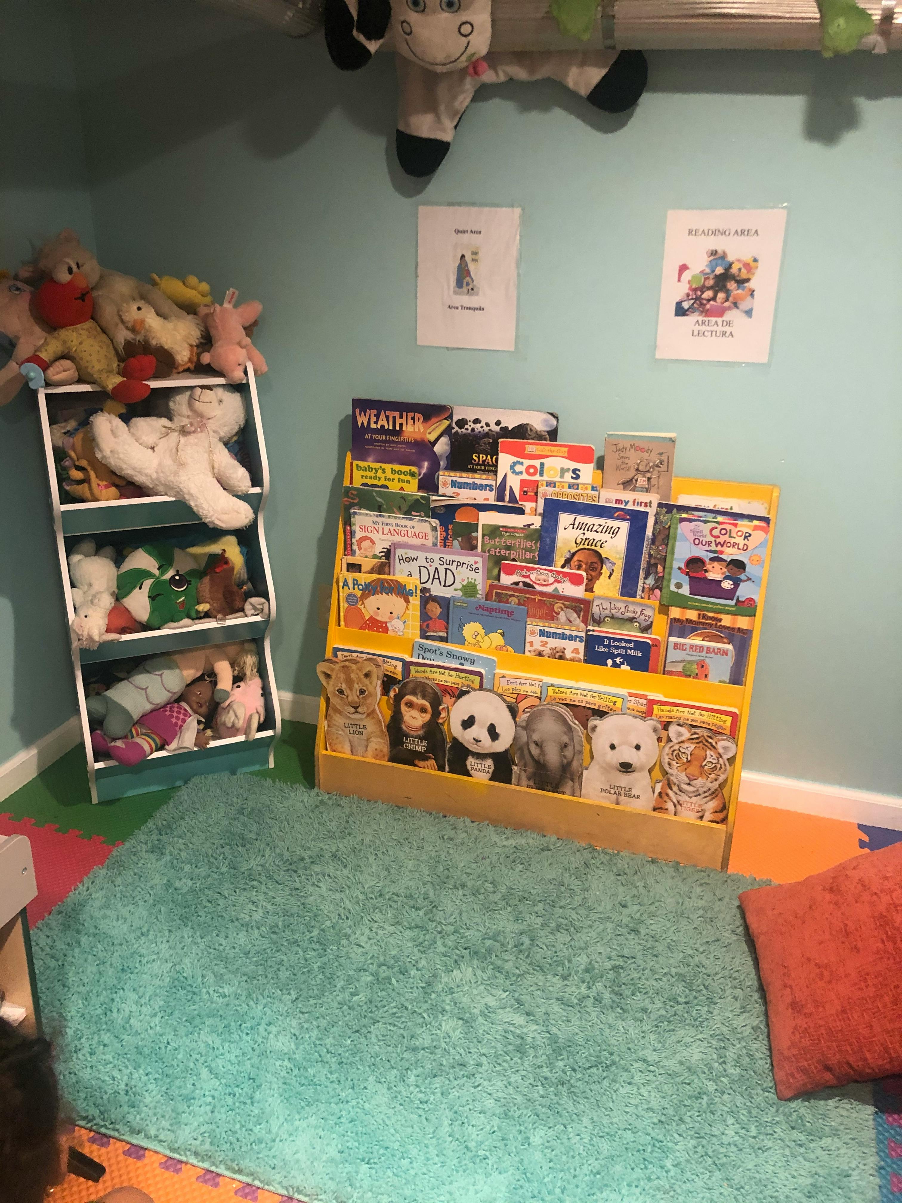 Bookshelf with children's books and stuffed animals in a room