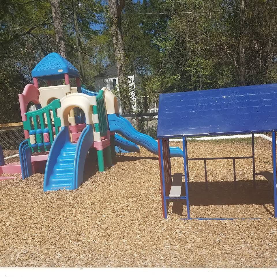 Playground with slides and a small blue shelter