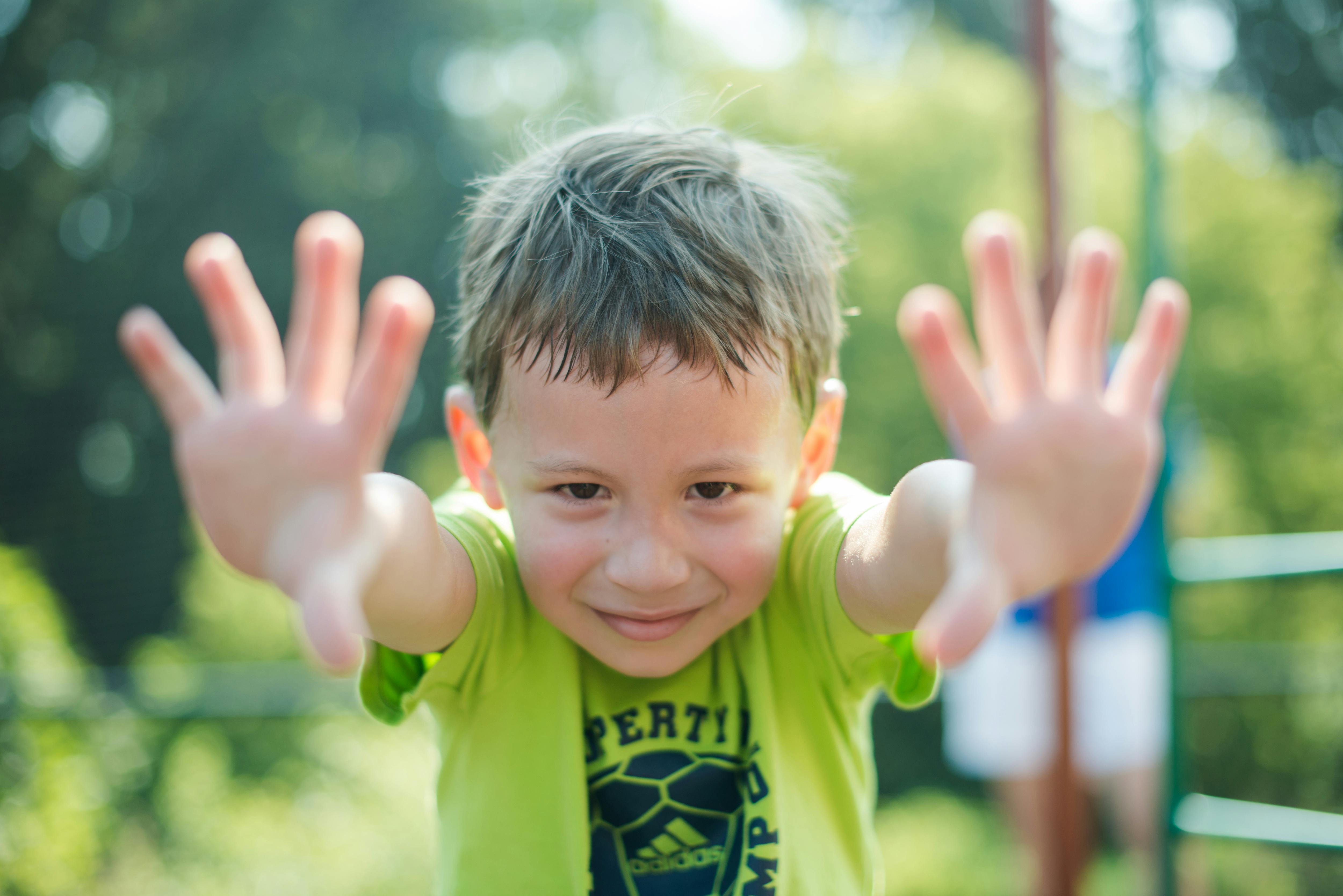 Child with hands outstretched towards the viewer