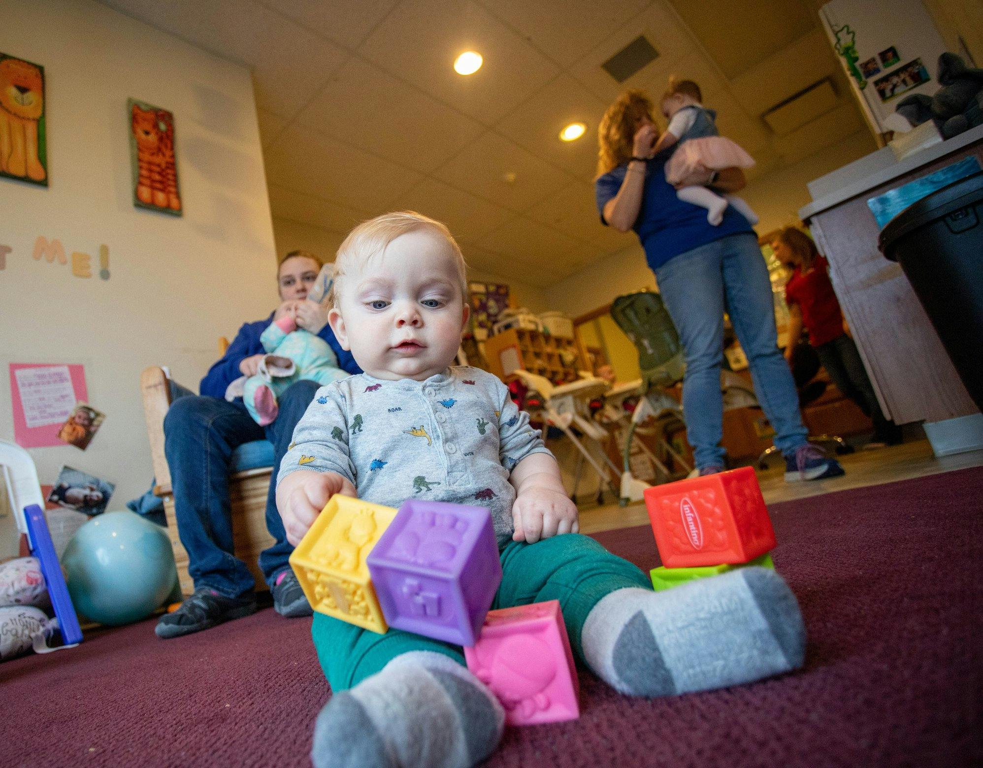 Child playing with colorful blocks on the floor