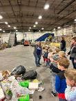 Adults and children in a warehouse