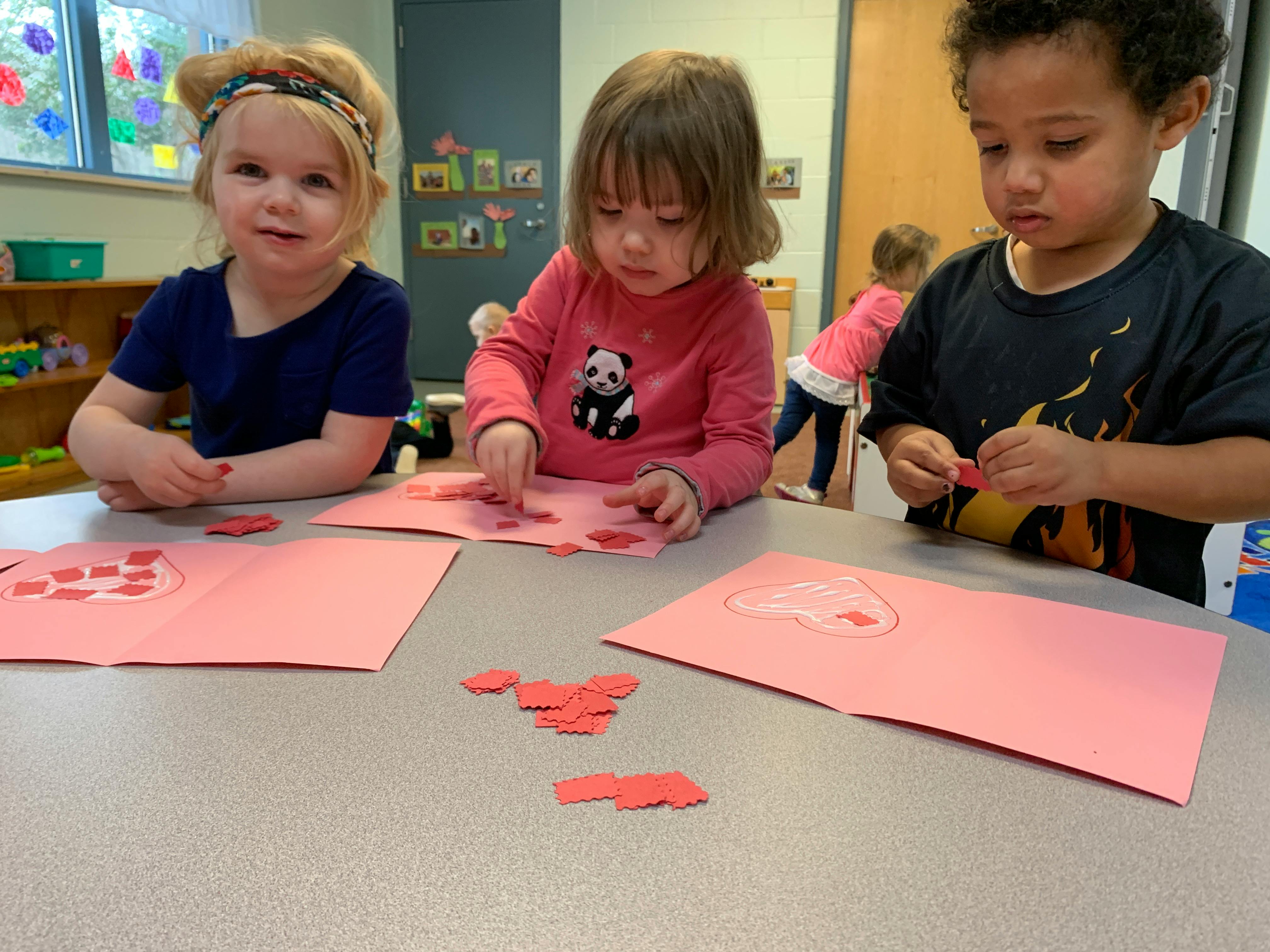 Three children doing crafts at a table