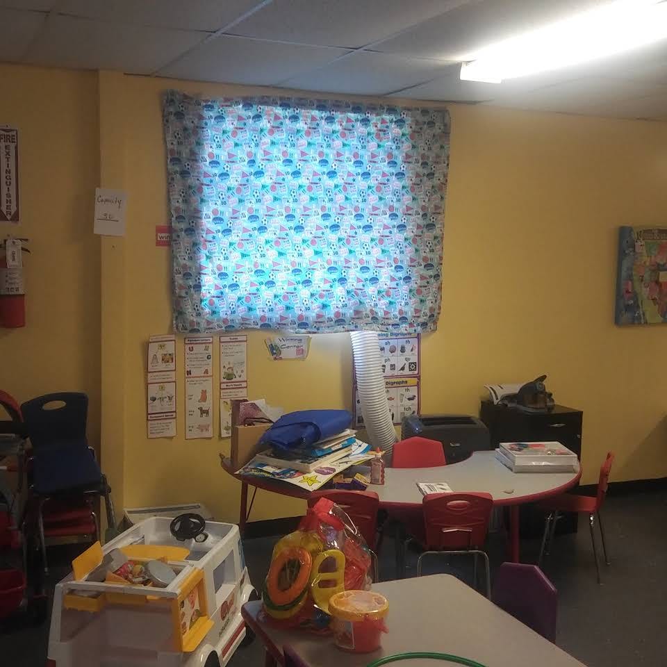 Classroom with small tables, chairs, and toys