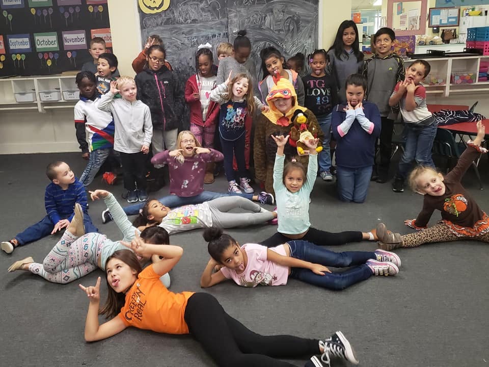 Group of children posing in a classroom