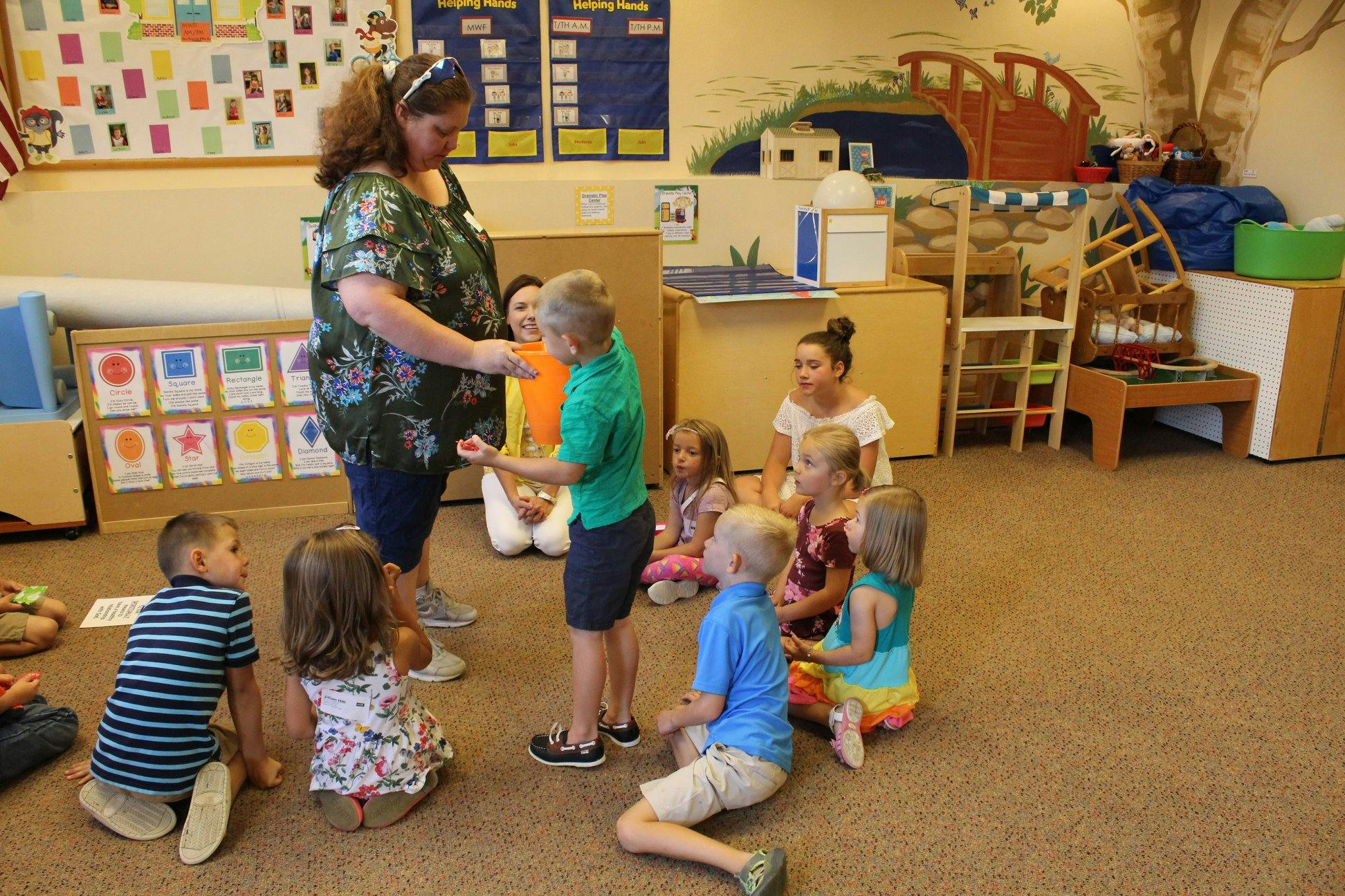 Adults and children gathered in a classroom