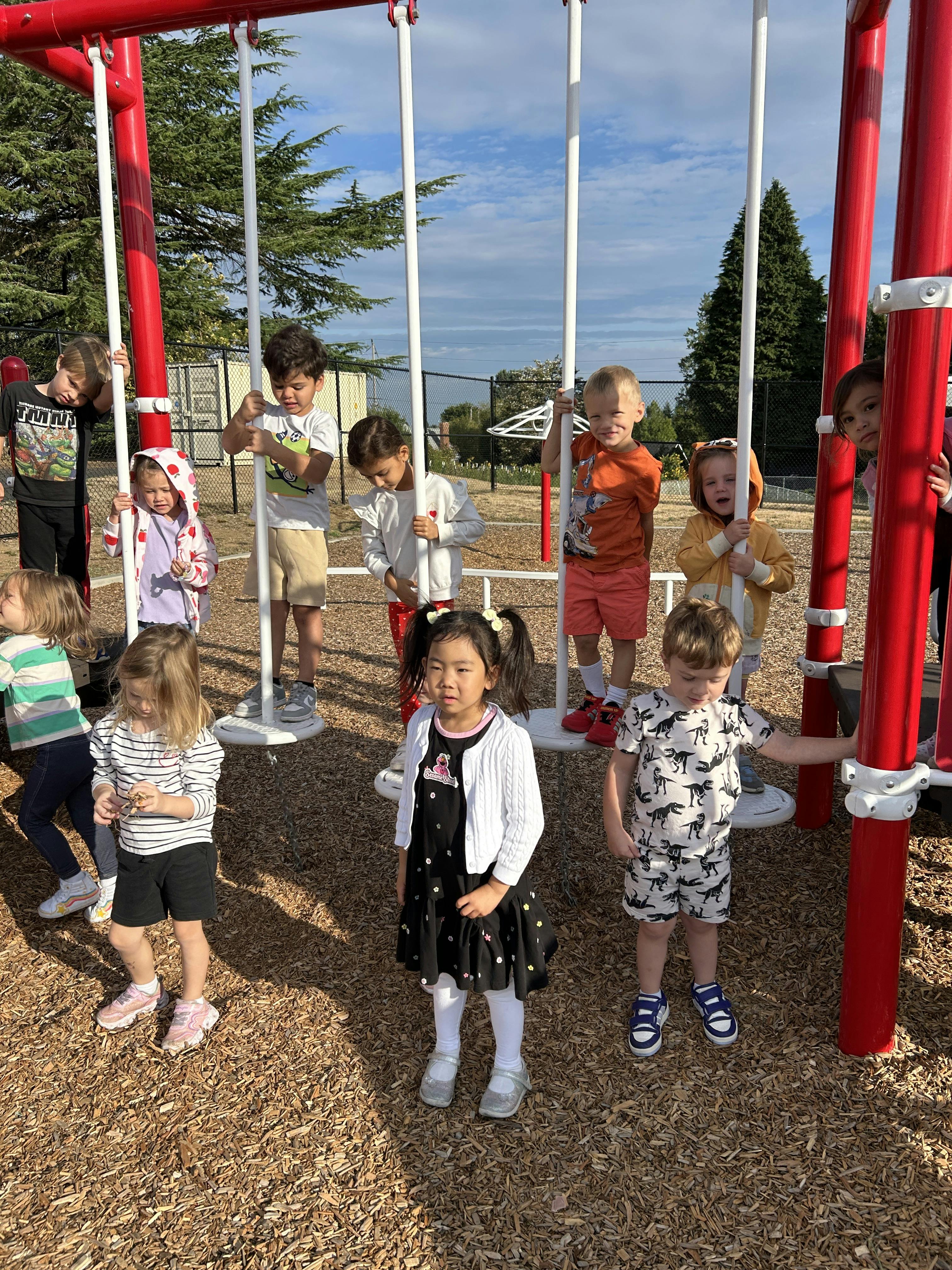 Children playing on a swing set at a playground