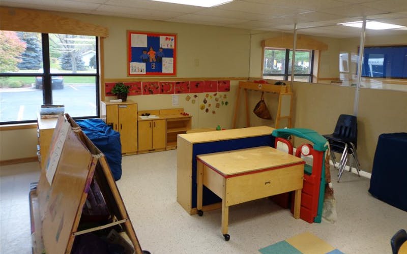 Classroom with child-sized furniture and artwork on the walls