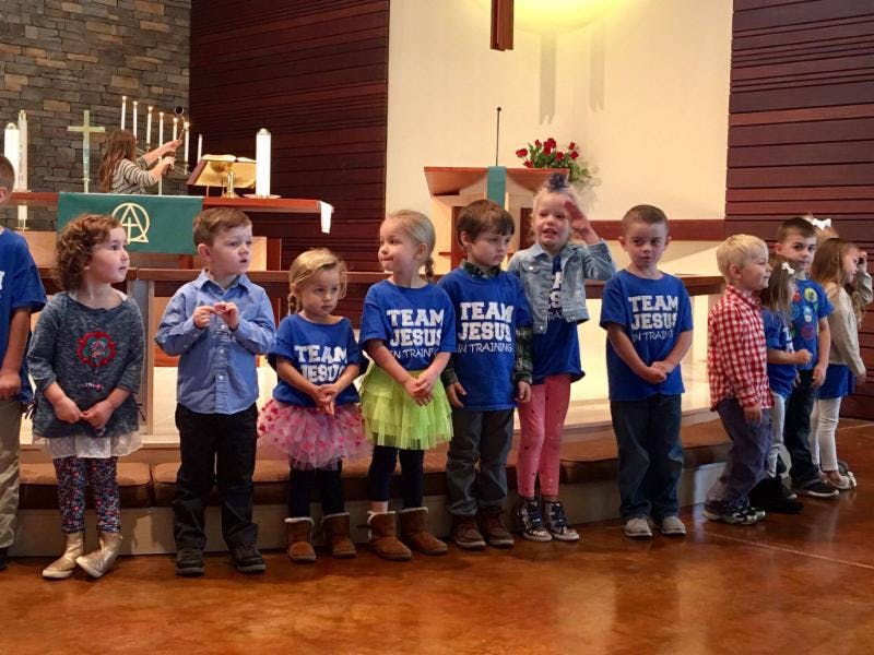 Children standing in a line in a church