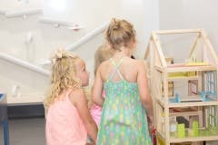 Children looking at a dollhouse